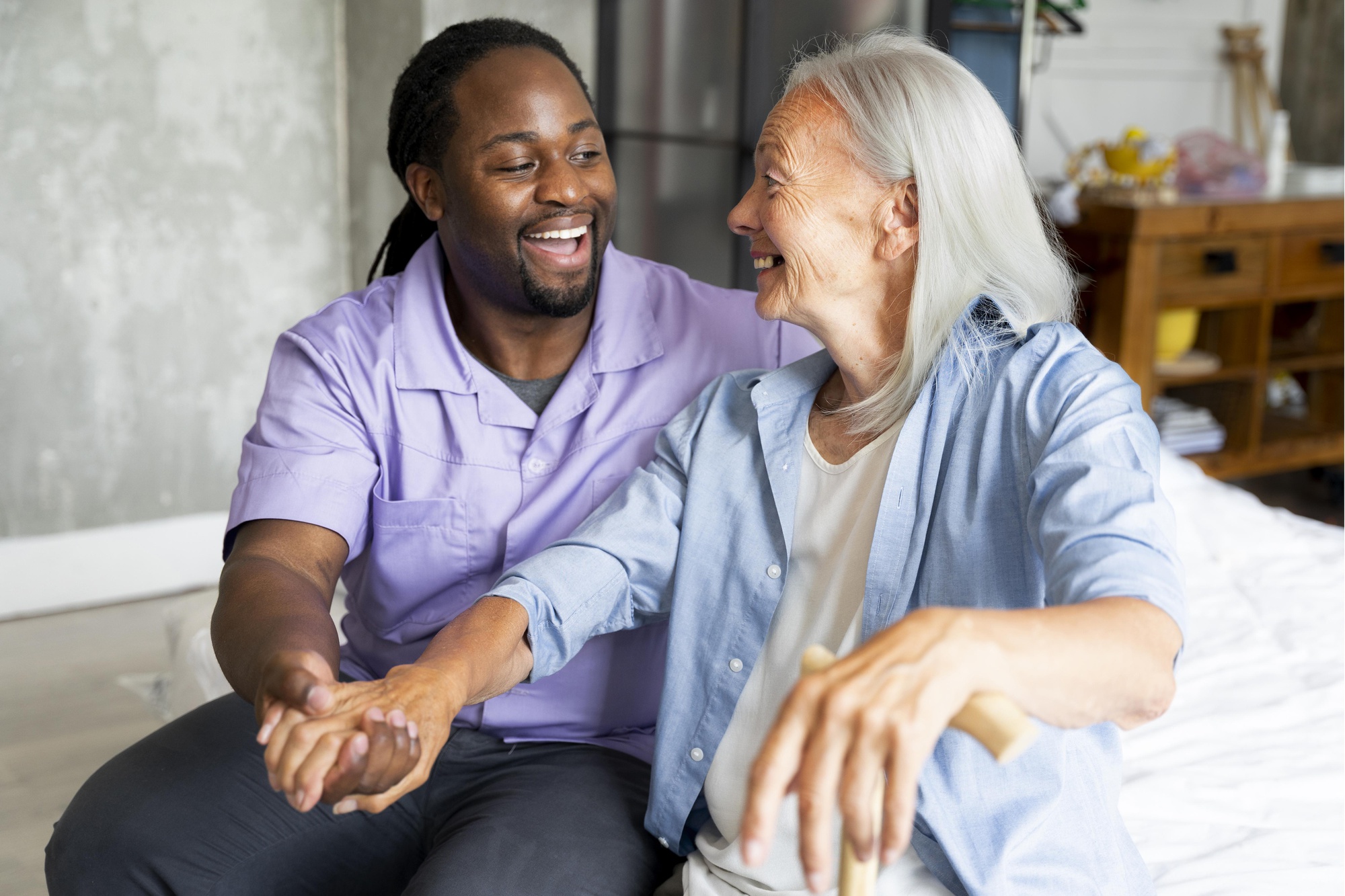 A care worker sharing a smile with an older woman